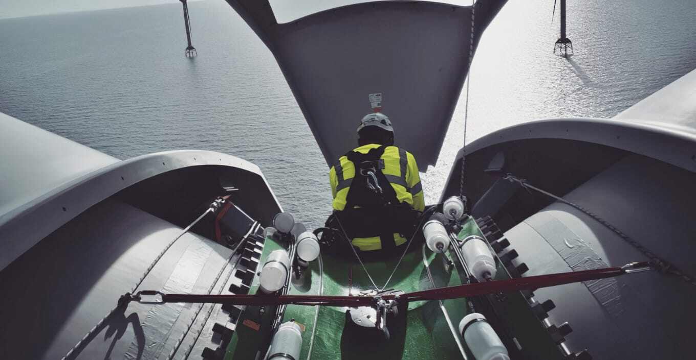 Engineer sitting on wind turbine