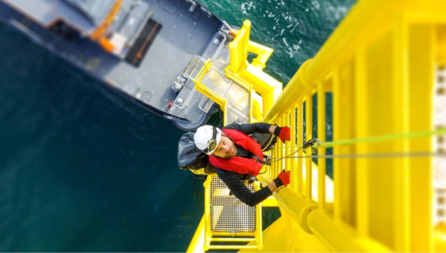 Man climbing wind turbine ladder