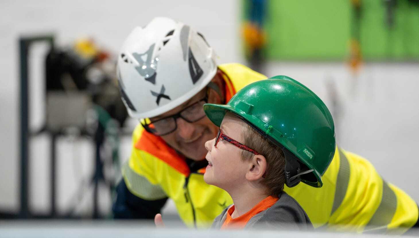 Man and young boy in hardhats