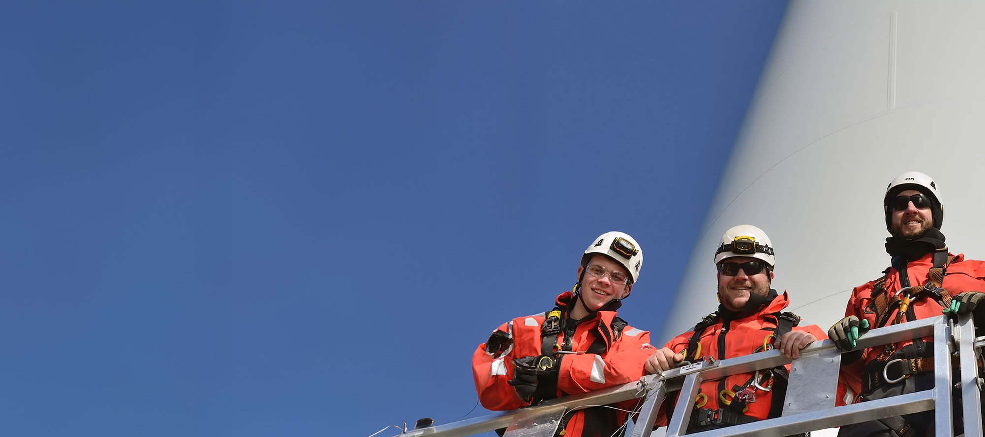 OEG team standing in front of wind turbine