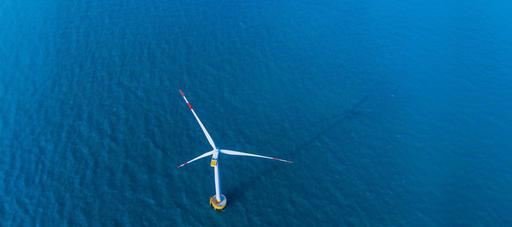 Birdseye view of a wind turbine at sea