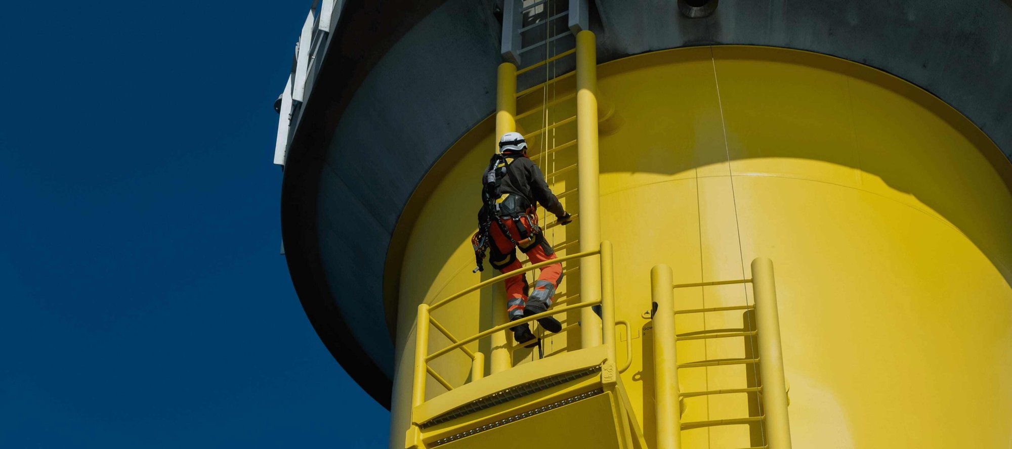 Man climbing wind turbine