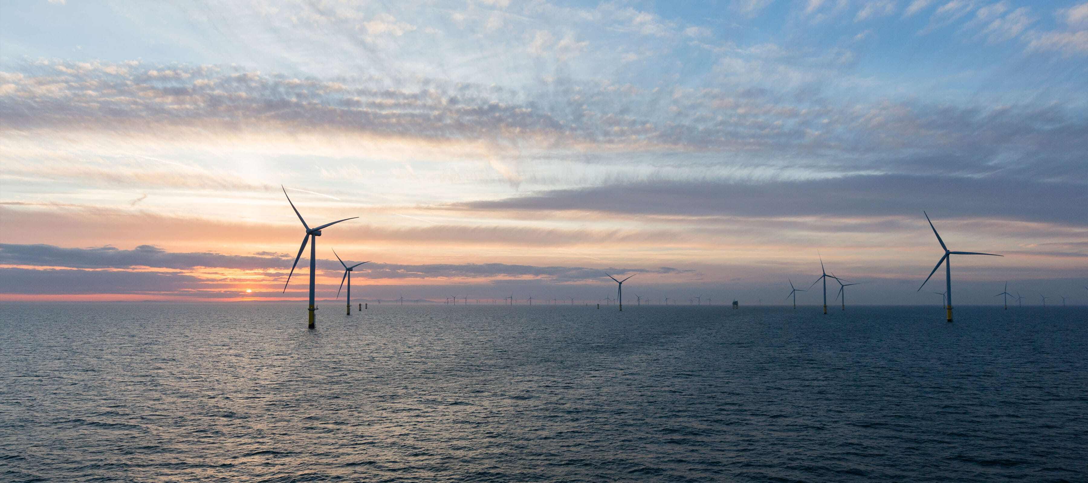 Wind turbines with sunset in background