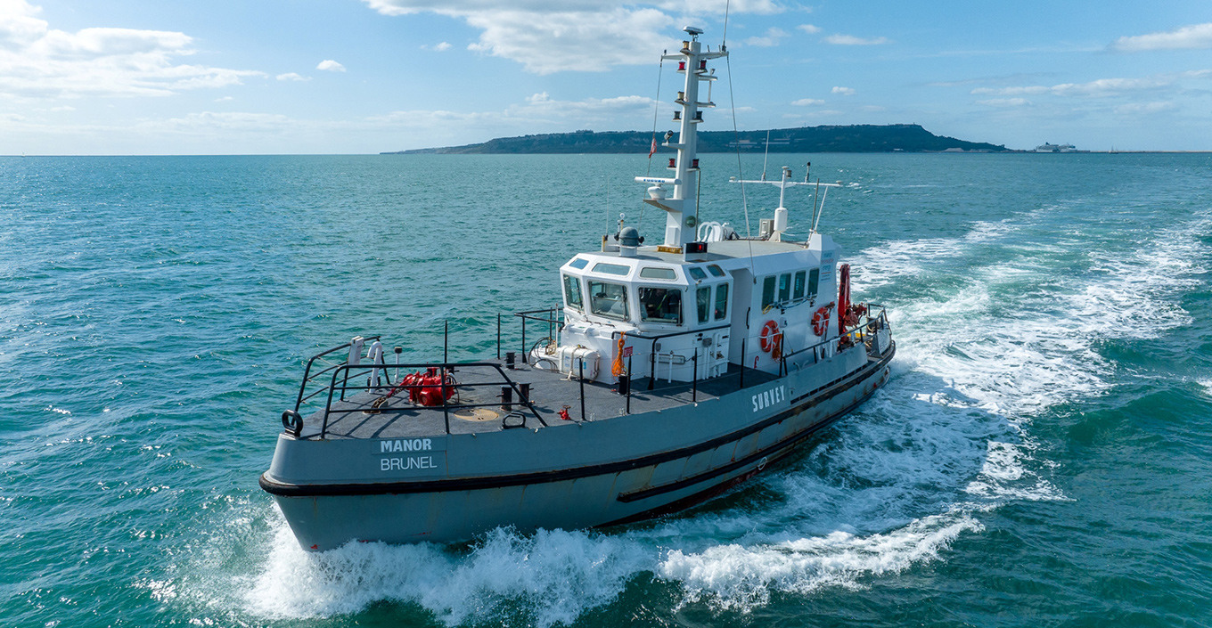 The Manor Brunel survey vessel sailing through the sea.